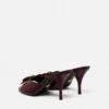 Mules à nœud Opera en cuir verni 85 mm Mules à nœud Opera en cuir verni 85 mm
